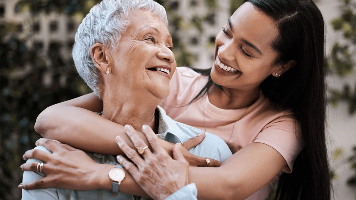 Image of woman hugging an elder woman